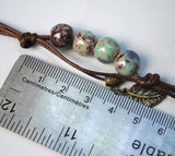 Set of 5 glazed ceramic bracelets with leaf charm