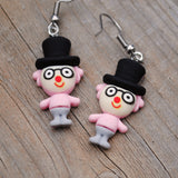 Weird little circus guys with fancy hats earrings