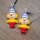 Weird little circus guys with fancy hats earrings