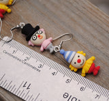 Weird little circus guys with fancy hats earrings